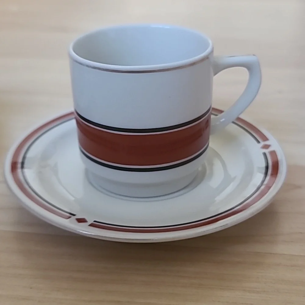 A set of 2 cups & saucers with red-maroon and black designs, and golden details